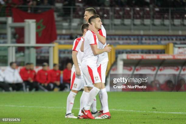 Dusan Tadic celebrates with teammates after scouring during the international friendly football match between Marocco and Serbia at Olympic Grande...