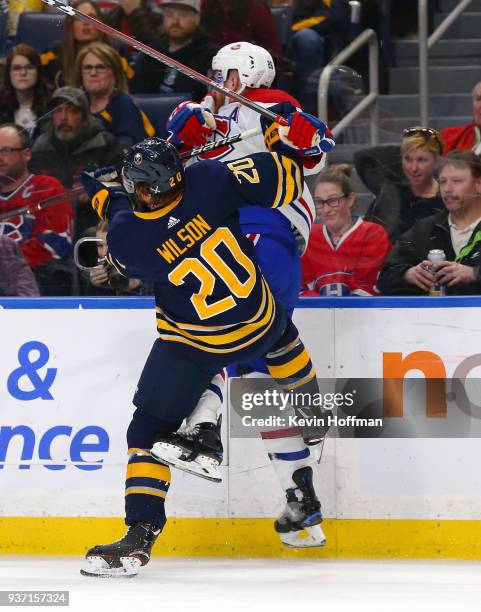 Scott Wilson of the Buffalo Sabres checks Jeff Petry of the Montreal Canadiens during the second period at KeyBank Center on March 23, 2018 in...