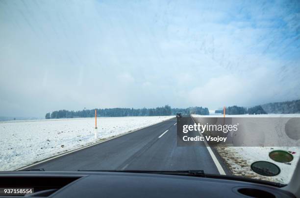 the way forward, driving in snow, austria - vsojoy stock pictures, royalty-free photos & images