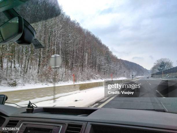 traveling on the road in snow, austria - vsojoy fotografías e imágenes de stock