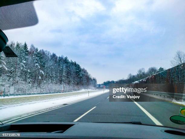 driving on the road in snow, austria - vsojoy stockfoto's en -beelden