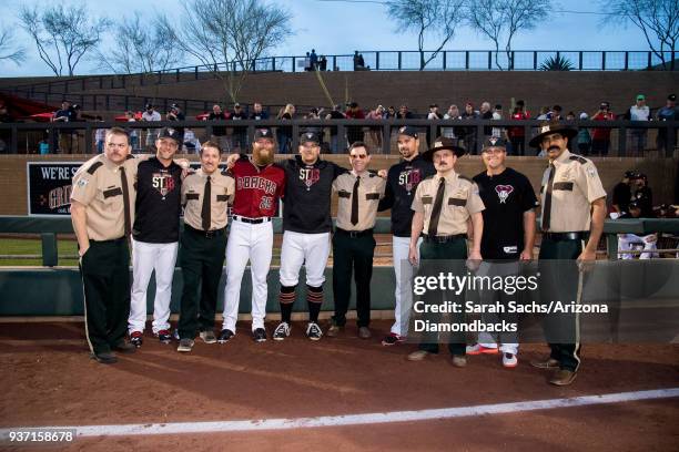 Brad Boxberger, Archie Bradley, Andrew Chafin, T.J. McFarland, and Kris Medlen of the Arizona Diamondbacks pose for a photo with actors Jay...