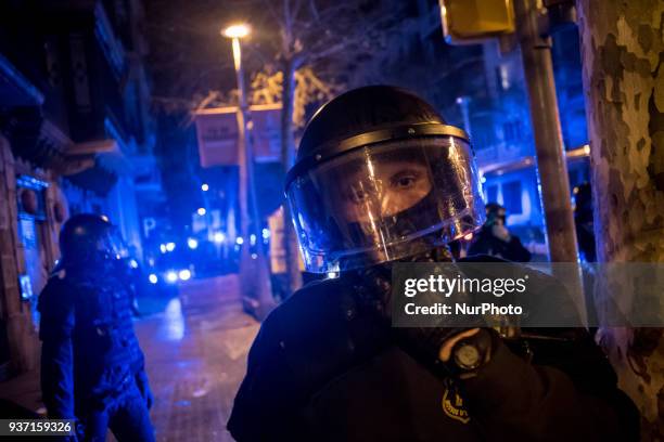 In Barcelona, Spain , a police officer stands guard close to Spanish government delegation headquarters in Catalonia as thousands go in the streets...