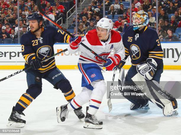 Linus Ullmark and Sam Reinhart of the Buffalo Sabres defend the net against Brendan Gallagher of the Montreal Canadiens during an NHL game on March...