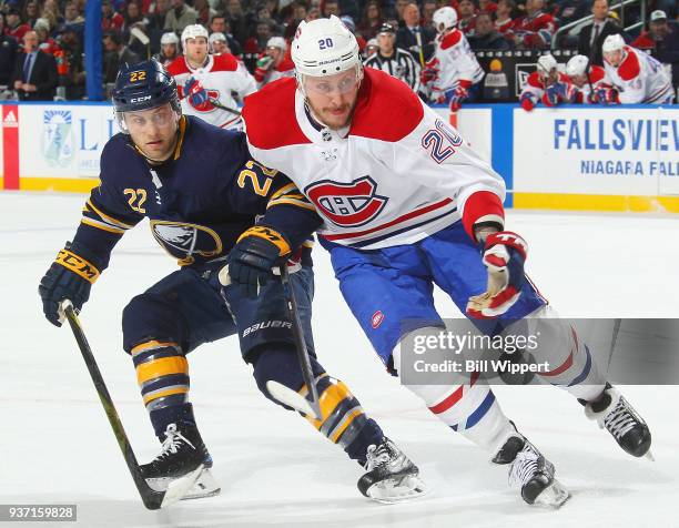 Johan Larsson of the Buffalo Sabres and Nicolas Deslauriers of the Montreal Canadiens chase the puck during an NHL game on March 23, 2018 at KeyBank...