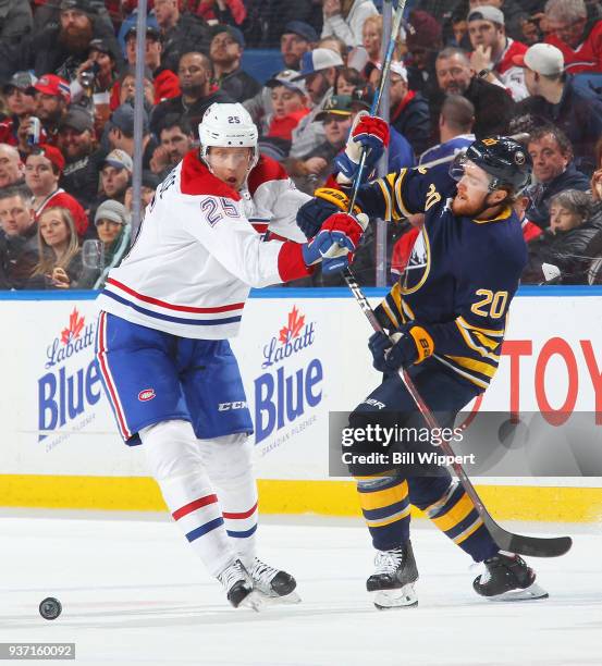 Jacob de la Rose of the Montreal Canadiens and Scott Wilson of the Buffalo Sabres collide while chasing the puck during an NHL game on March 23, 2018...