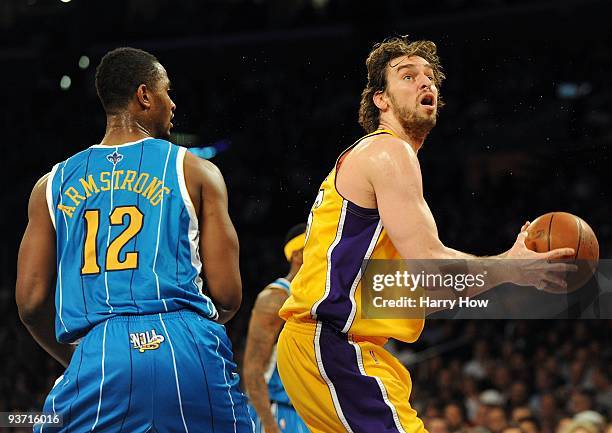 Pau Gasol of the Los Angeles Lakers attempts a shot in front of Hilton Armstrong of the New Orleans Hornets at Staples Center on December 1, 2009 in...