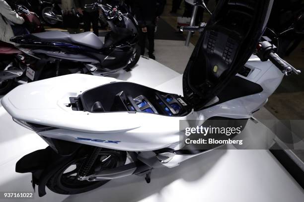 Honda Motor Co. Mobile Power Pack sits inside a PCX Electric scooter on display at the Tokyo Motorcycle Show in Tokyo, Japan, on Friday, March 23,...