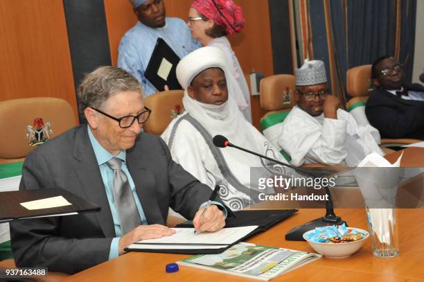 In this handout image provided by the Gates Archive, Bill Gates, Co-Chair and Trustee Bill & Melinda Gates Foundation, signs a Routine Immunization...