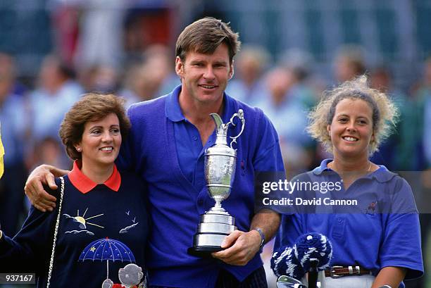 Nick Faldo of England with the Claret Jug alongside wife Gill and caddy Fanny Sunesson after winning the British Open at Muirfield in Scotland. \...