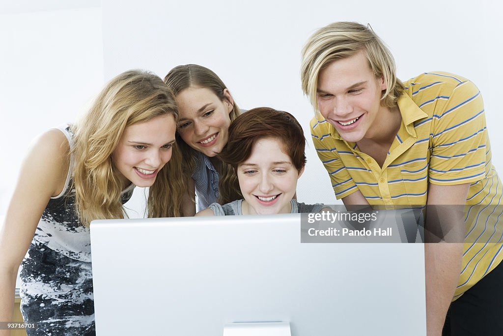 Computer System Friends Group Of Friends Using Computer Smiling High-Res Stock Photo - Getty Images