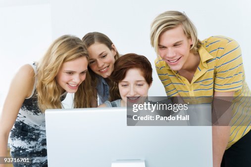 Computer Friends Example Group Of Friends Using Computer Smiling High-Res Stock Photo - Getty Images