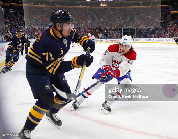 Evan Rodrigues of the Buffalo Sabres defends as Jacob de la Rose of the Montreal Canadiens forechecks during the third period at KeyBank Center on...