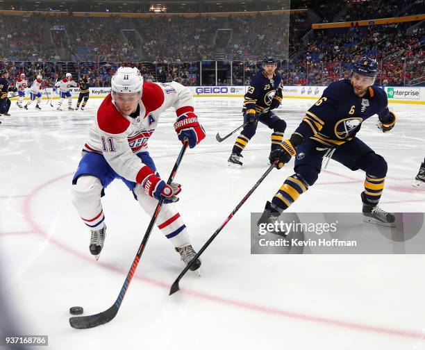 Brendan Gallagher of the Montreal Canadiens with the puck as Marco Scandella of the Buffalo Sabres defends during the third period at KeyBank Center...