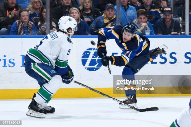 Derrick Pouliot of the Vancouver Canucks blocks a shot by Vladimir Sobotka of the St. Louis Blues at Scottrade Center on March 23, 2018 in St. Louis,...