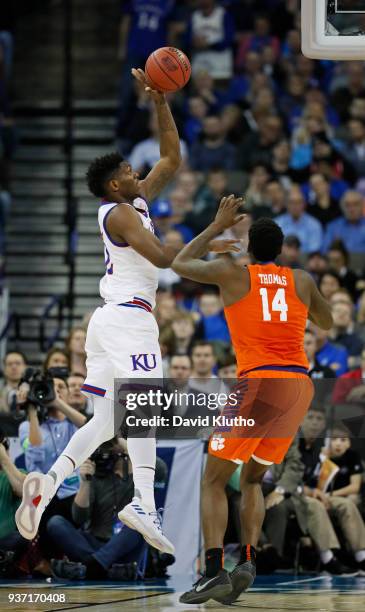 Kansas forward Silvio De Sousa drives to the basket on Clemson forward Elijah Thomas in the first half during the third round of the 2018 NCAA Photos...