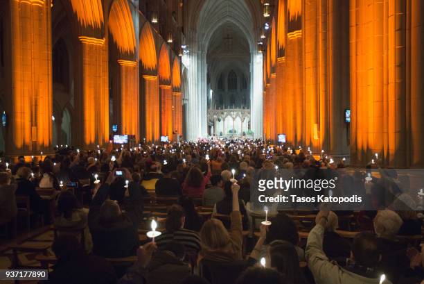 People take part in a candle light vigil at the Washington National Cathedral ahead of Saturday's March For Our Lives rally, March 23, 2018 in...