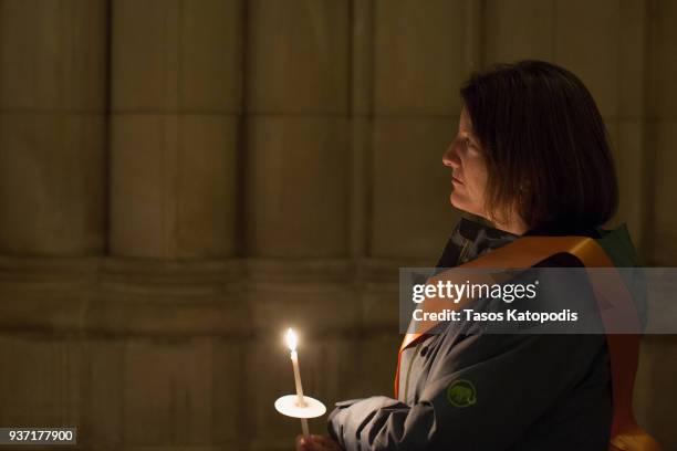 People take part in a candle light vigil at the Washington National Cathedral ahead of Saturday's March For Our Lives rally, March 23, 2018 in...