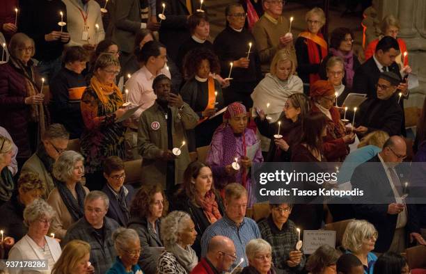 People take part in a candle light vigil at the Washington National Cathedral ahead of Saturday's March For Our Lives rally, March 23, 2018 in...