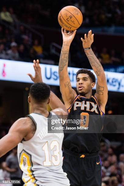 Marquese Chriss of the Phoenix Suns shoots over Tristan Thompson of the Cleveland Cavaliers during the second half at Quicken Loans Arena on March...