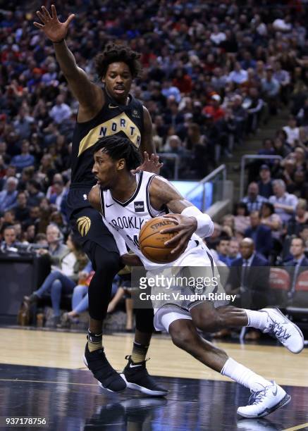 Rondae Hollis-Jefferson of the Brooklyn Nets dribbles the ball as Lucas Nogueira of the Toronto Raptors defends during the second half of an NBA game...