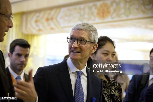 Tim Cook, chief executive officer of Apple Inc., center, arrives at the China Development Forum in Beijing, China, on Saturday, March 24, 2018....