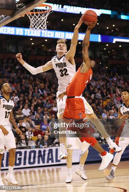 Matt Haarms of the Purdue Boilermakers defends a shot by Keenan Evans of the Texas Tech Red Raiders during the first half in the 2018 NCAA Men's...