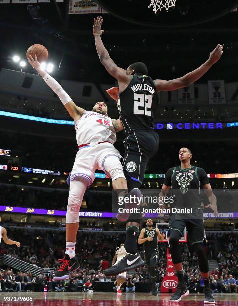 Denzel Valentine of the Chicago Bulls puts up a shot against Khris Middleton of the Milwaukee Bucks at the United Center on March 23, 2018 in...
