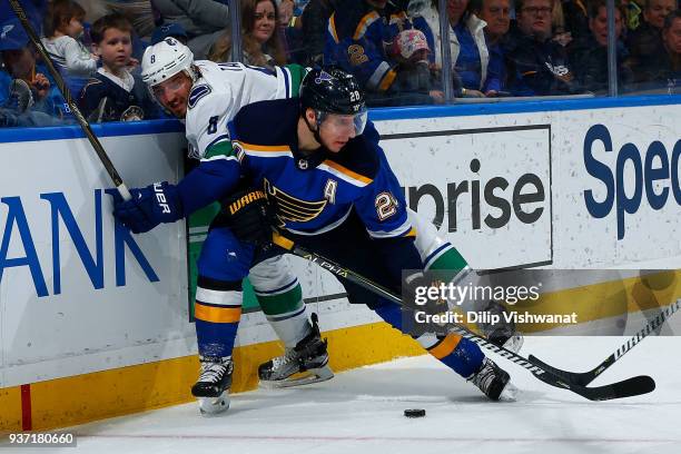 Alexander Steen of the St. Louis Blues holds off Chris Tanev of the Vancouver Canucks to gain control of the puck at Scottrade Center on March 23,...