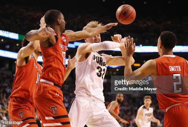 Matt Haarms of the Purdue Boilermakers battles for the ball with Keenan Evans and Zhaire Smith of the Texas Tech Red Raiders during the first half in...