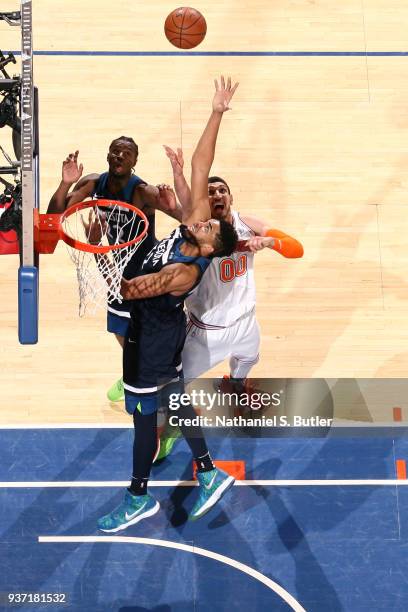 Karl-Anthony Towns of the Minnesota Timberwolves and Enes Kanter of the New York Knicks jump for the rebound on March 23, 2018 at Madison Square...