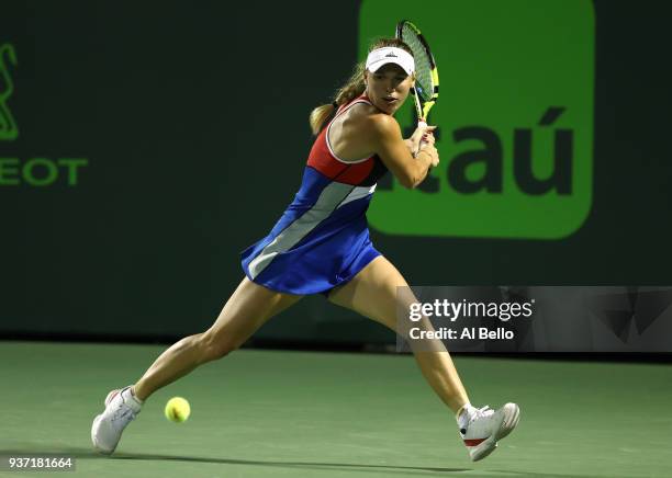 Caroline Wozniaki of Denmark plays a shot against Monica Puig of Puerto Rico during Day 5 of the Miami Open at the Crandon Park Tennis Center on...