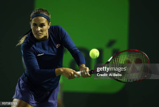 Monica Puig of Puerto Rico plays a shot against Caroline Wozniaki of Denmark during Day 5 of the Miami Open at the Crandon Park Tennis Center on...
