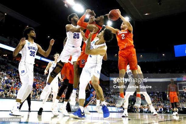 Marques Bolden and Gary Trent Jr. #2 of the Duke Blue Devils battle for the ball with Tyus Battle and Matthew Moyer of the Syracuse Orange during the...