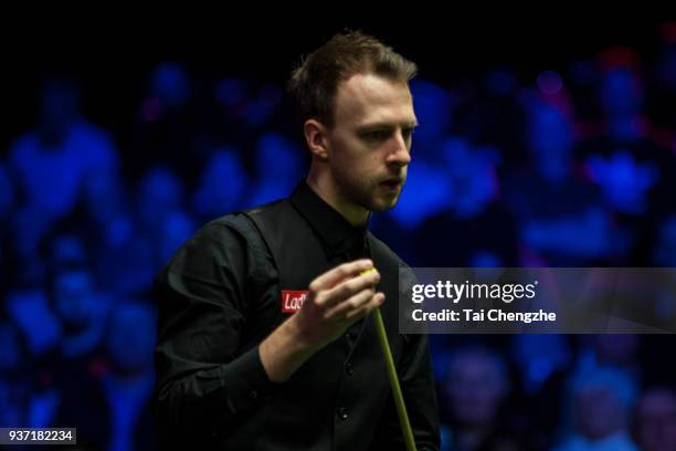 Judd Trump of England chalks the cue during his semi-final match against Ronnie O'Sullivan of England on day five of 2018 Ladbrokes Players...