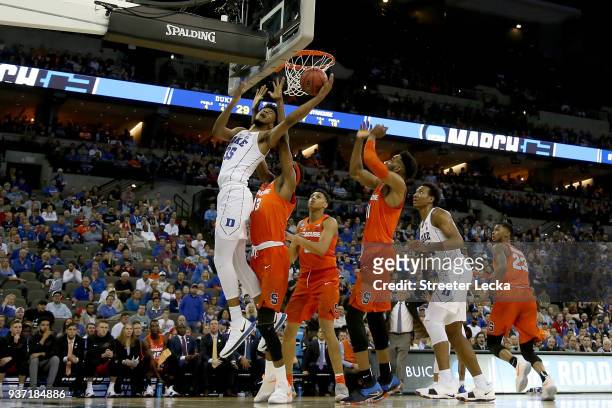 Marvin Bagley III of the Duke Blue Devils shoots the ball over Matthew Moyer and Paschal Chukwu of the Syracuse Orange during the first half in the...