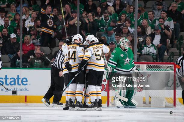 Nick Holden, Adam McQuaid and the Boston Bruins celebrate a goal against the Dallas Stars at the American Airlines Center on March 23, 2018 in...