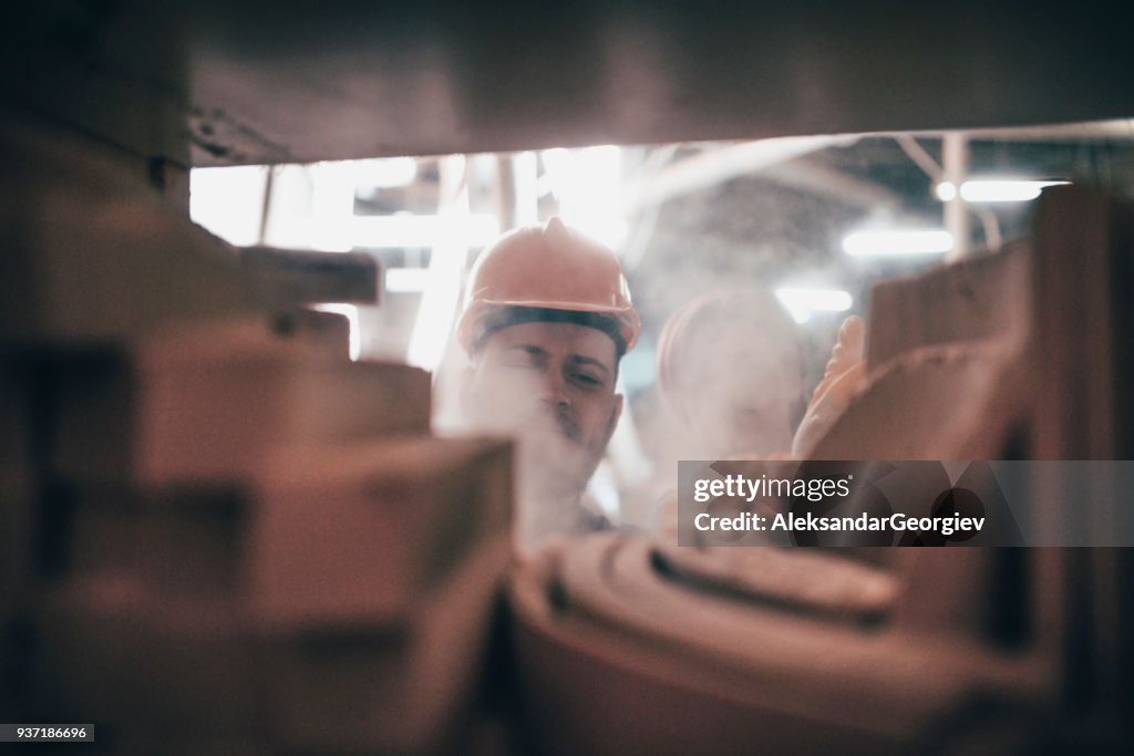 Young Carpenters Arrange the Wooden Chair Sample Parts on Shelf in Wood Factory