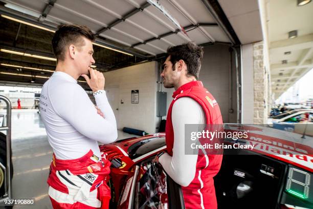 Toni Vilander, of Finland, L, and Miguel Molina, of Spain, talk in the paddock before practice for the Pirelly World Challenge Grand Prix of Texas at...