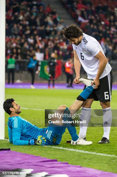 Goalkeeper Mohamed El-Shenawy of Egypt getting help from his teammate Ahmed Hegazi to stretch his left leg during the International Friendly between...