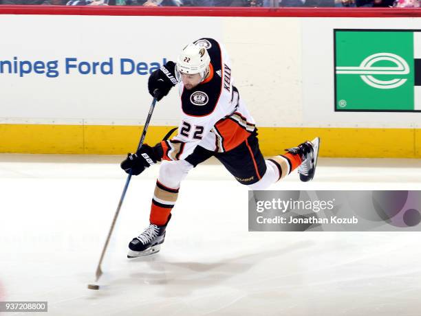 Chris Kelly of the Anaheim Ducks shoots the puck down the ice during third period action against the Winnipeg Jets at the Bell MTS Place on March 23,...