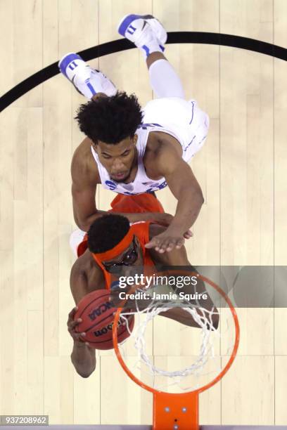 Paschal Chukwu of the Syracuse Orange attempts a shot under pressure from Marvin Bagley III of the Duke Blue Devils in the 2018 NCAA Men's Basketball...