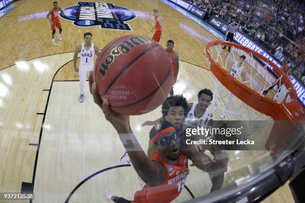 Paschal Chukwu of the Syracuse Orange dunks the ball against Marvin Bagley III of the Duke Blue Devils in the 2018 NCAA Men's Basketball Tournament...