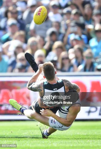 Hamish Hartlett of Port Adelaide tackled by Cameron Sutcliffe of the Dockers during the round one AFL match between the Port Adelaide Power and the...