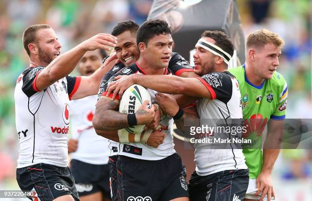 Issac Luke of the Warriors is congratulated by team mates after scoing a try during the round three NRL match between the Canberra Raiders and the...