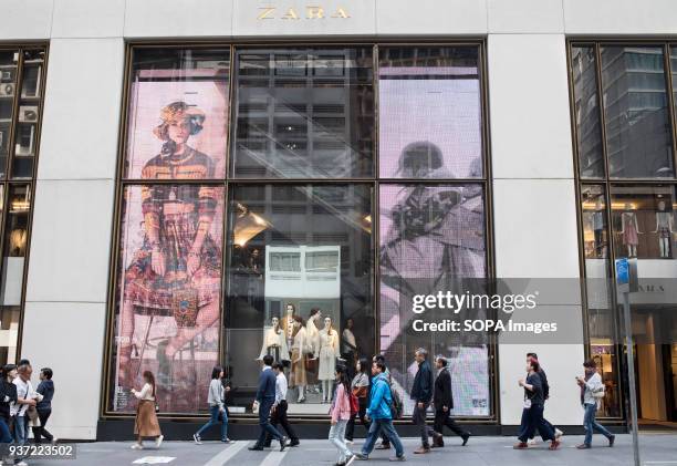 Pedestrians walks past Spanish multinational retailer Zara in Queen's Road, Central district.