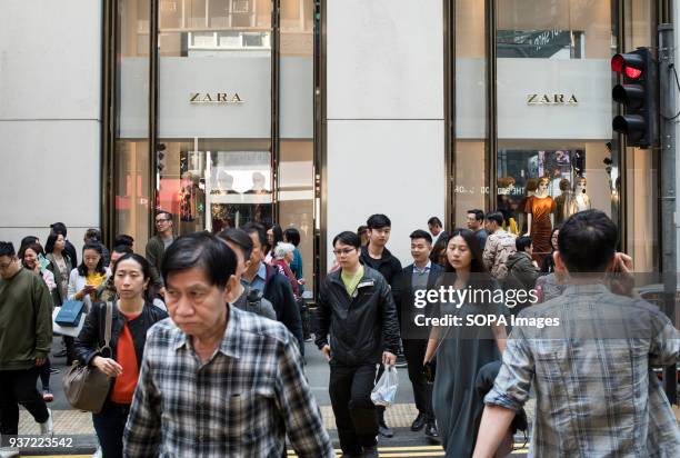 Pedestrians walks past Spanish multinational retailer Zara in Queen's Road, Central district.