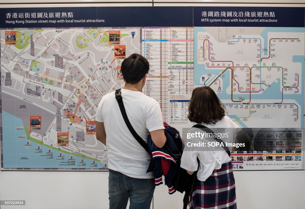 Traveler reading Hong Kong's MTR subway map...