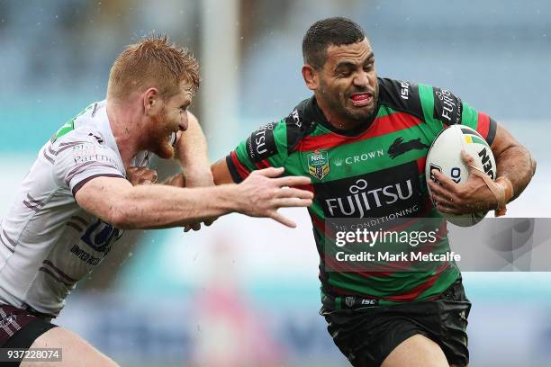 Greg Inglis of the Rabbitohs hands off Brad Parker of the Sea Eagles during the round three NRL match between the South Sydney Rabbitohs and the...