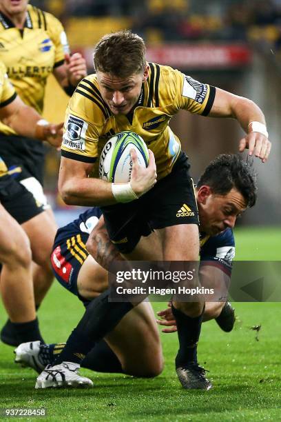 Beauden Barrett of the Hurricanes is tackled by Elliot Dixon of the Highlanders during the round six Super Rugby match between the Hurricanes and the...